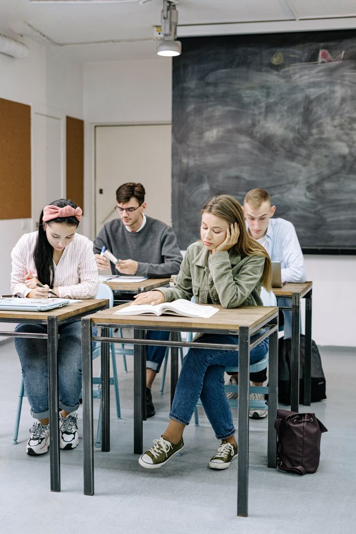 Mastering the First Impression: Your intriguing post title goes here A group of teenagers focusing on studies in a classroom with a blackboard.